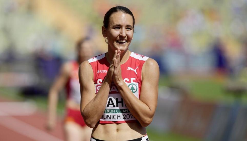 Annina Fahr, of Switzerland, reacts after winning a Women's 400 meters hurdles heat during the athletics competition in the Olympic Stadium at the European Championships in Munich, Germany, Wednesday, Aug. 17, 2022. (AP Photo/Martin Meissner)